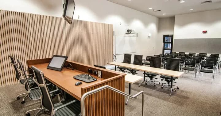 Moot court equipped with essential components magistrate's bench, a witness box, and versatile furniture that can be easily configured for various setups.